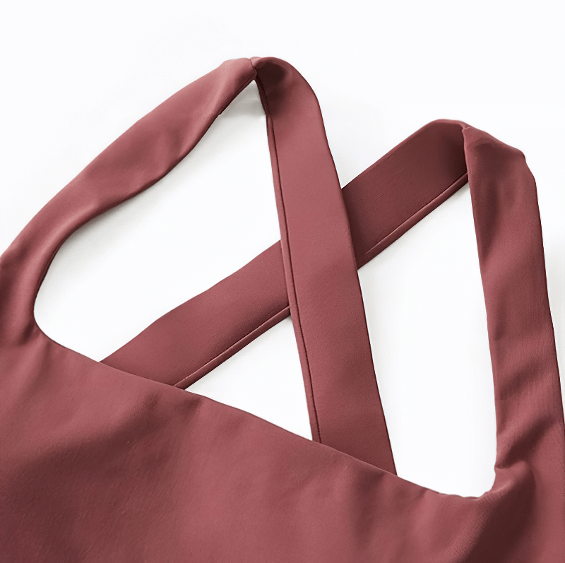Close-up of a stylish cross back detail on a pink Nylon and Spandex running tank top, perfect for women's high-intensity workouts.